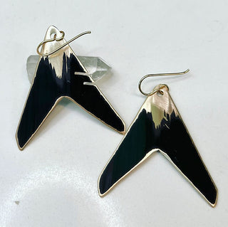 Black and gold earrings on a white background