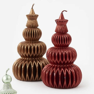 Two ribbed, tiered decorative ornaments or candle holders in metallic bronze and deep red, shown on a clean white background with a small green ornament partially visible in the lower left corner.