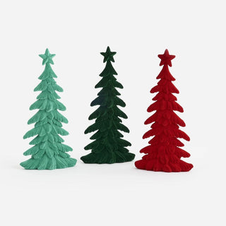 Three small decorative Christmas tree ornaments in mint green, dark green, and red, each with a star topper, displayed against a clean white background.