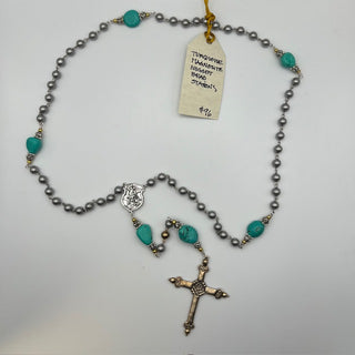 Rosary with turquoise-colored nugget bead stations, gray beads, a devotional medal, and a cross.