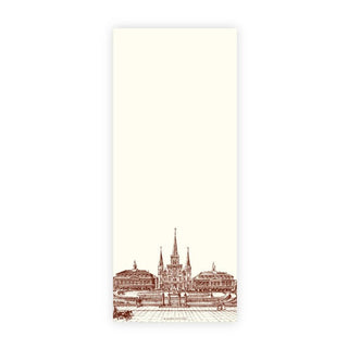A cream-colored rectangular notepad with a sepia architectural illustration of a cathedral and city square at the bottom, shown on a white background with partial product text on the right.