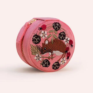 A round pink fabric zippered pouch featuring a detailed embroidered design of a brown mouse surrounded by black berries, white flowers, and green leaves, shown on a light beige background.