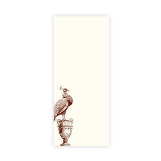 A vertical cream-colored rectangular notepad featuring a sepia-toned illustration of a peacock standing on an ornate pedestal near the lower left, set against a plain white background.